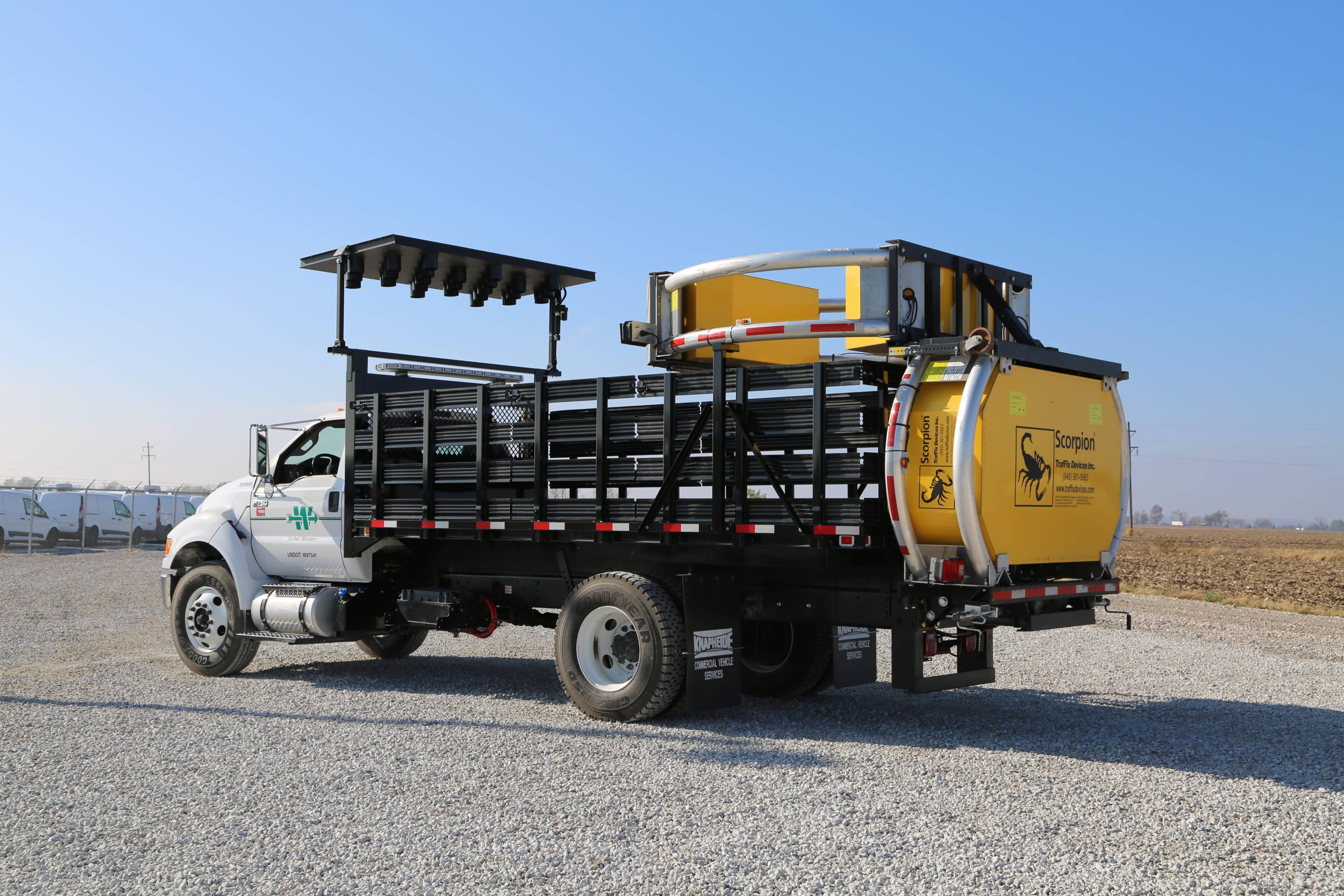 Archer Western Ford F-750 with a Knapheide Cargo Hauler Platform Body 163B with Stake Racks and Scorpion