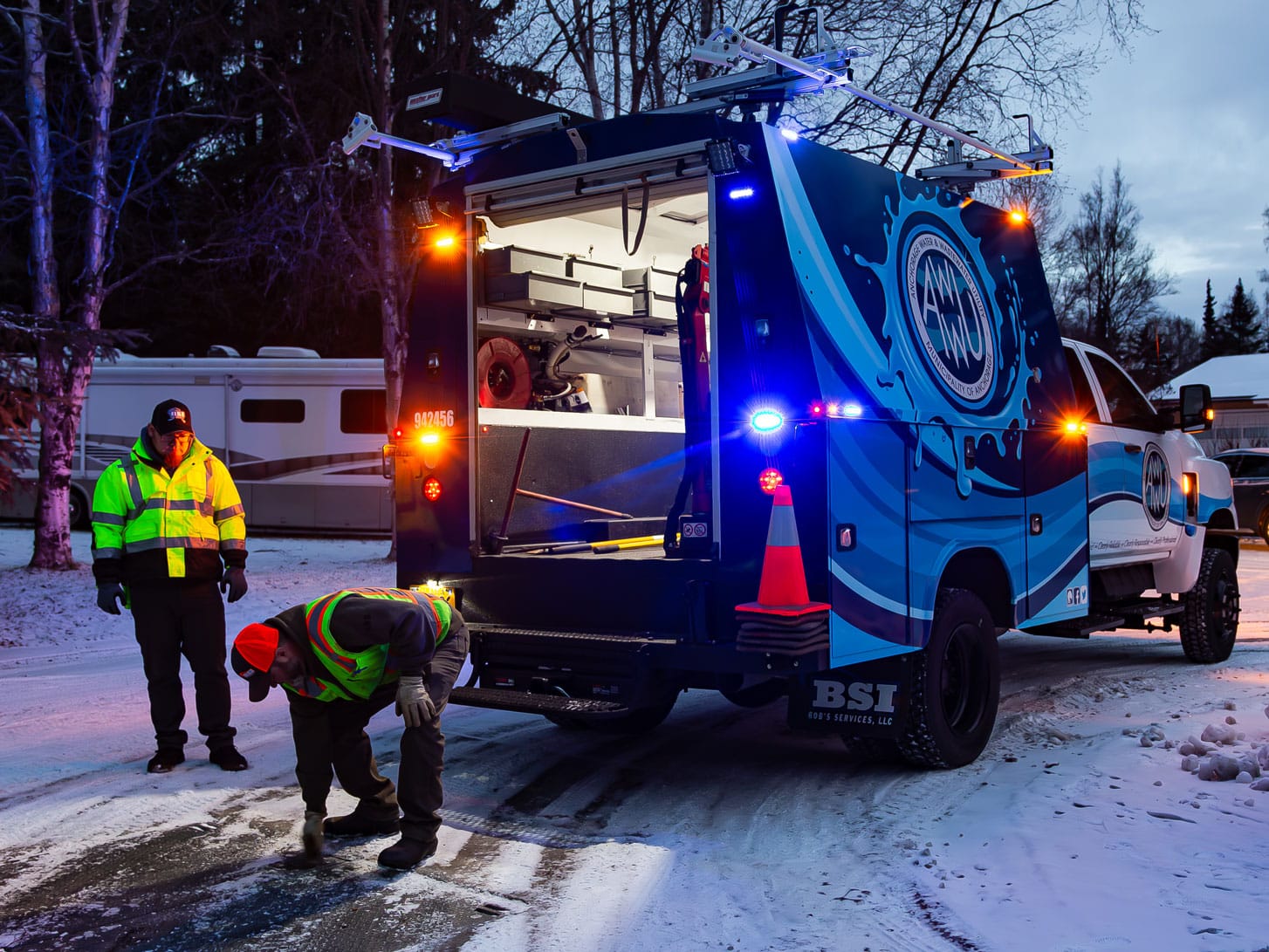 anchorage water and wastewater utility enclosed service truck and field crew on the jobsite